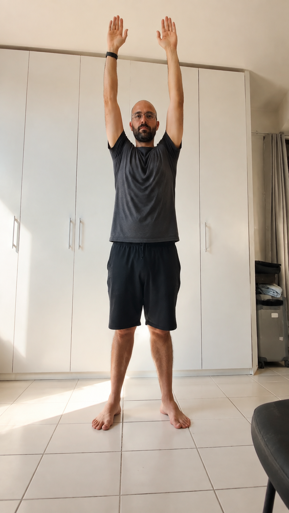 The WakeFlow founder doing a gentle overhead stretch in natural morning light